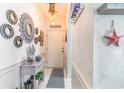 Bright entryway with coastal decor and mirrors at 4773 Wild Iris Dr. # 5-202, Myrtle Beach, SC 29577