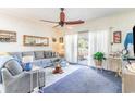 Living room with gray sofa, glass coffee table, and access to balcony at 4773 Wild Iris Dr. # 5-202, Myrtle Beach, SC 29577