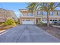 Two-story townhome with brick exterior, balcony, and driveway at 502 Hay Hill Ln. # B, Myrtle Beach, SC 29579