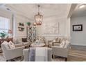Bright living room featuring comfortable seating, a circular coffee table, and artwork at 5508 Whistling Duck Dr., North Myrtle Beach, SC 29582