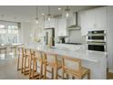 Modern kitchen with white cabinets, quartz counters, and gold accents at 8579 Balmy Breeze Pl. # 43, Myrtle Beach, SC 29572