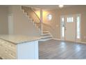 Open living area with stairs and laminate flooring at 9215 Greeneedle Pl., Murrells Inlet, SC 29576