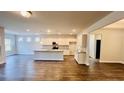 Spacious kitchen boasts an island, hardwood floors, and modern appliances at 1135 Nw Rosefield Way, Calabash, NC 28467
