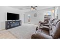 Inviting living room featuring plush seating, a ceiling fan, and a cozy fireplace at 141 Foxford Dr., Conway, SC 29526