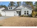 Two-story house with gray siding, three-car garage, and landscaped yard at 146 Caroline Ct., Murrells Inlet, SC 29576