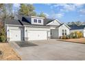 Two-story house with gray siding, three-car garage, and landscaped yard at 146 Caroline Ct., Murrells Inlet, SC 29576