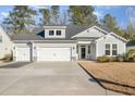 Two-story house with gray siding, three-car garage, and landscaped yard at 146 Caroline Ct., Murrells Inlet, SC 29576