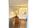 Open-concept living area with wood floors, stylish lighting, and a view into the kitchen at 15 Century St. # 15, Myrtle Beach, SC 29577
