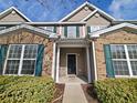 Townhome entrance with brick and siding exterior, landscaping, and walkway at 155 E Chenoa Dr. # E, Murrells Inlet, SC 29576