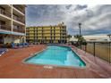 Community pool with lounge chairs near the beach at 202 75Th Ave. N # 5604/5605, Myrtle Beach, SC 29572