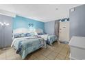 Bedroom with two beds, light blue walls, and access to balcony at 210 75Th Ave. N # 4141, Myrtle Beach, SC 29572