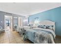 Bedroom with two beds, light blue walls, and ocean view at 210 75Th Ave. N # 4141, Myrtle Beach, SC 29572