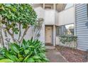 Condo entry with light-colored door and lush landscaping at 215 Baslow Ct. # 1-B, Myrtle Beach, SC 29572