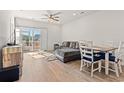 Open living area with L-shaped sofa, dining table, and sliding glass doors at 3518 Bells Lake Circle # 215, Longs, SC 29568