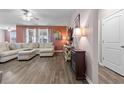 Comfortable living room showcasing a sectional sofa, stylish decor, and a hardwood floor at 421 Sunforest Way, Conway, SC 29526