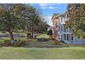 Landscaped backyard with pond and lush greenery at 4641 Lightkeepers Way # 3A, Little River, SC 29566