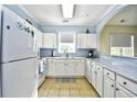 Efficient kitchen with white cabinets, granite countertops, and stainless steel appliances at 6015 Catalina Dr. # 431, North Myrtle Beach, SC 29582
