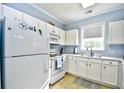 White kitchen cabinets, granite countertops, and a view into the dining area at 6015 Catalina Dr. # 431, North Myrtle Beach, SC 29582
