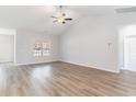 Open living area with hardwood-look floors, vaulted ceiling, and a large window at 643 Woodside Dr., Conway, SC 29526