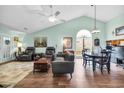 Spacious living room with vaulted ceilings, modern furniture, and abundant natural light from a large window at 6716 Wisteria Dr., Myrtle Beach, SC 29588
