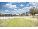 Scenic golf course view with lush green grass and a serene lake backdrop at 677 Tupelo Ln. # 301, Longs, SC 29568