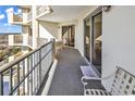 Spacious condo balcony with seating, offering relaxing ocean views at 9994 Beach Club Dr. # 1606, Myrtle Beach, SC 29572