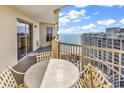 Condo balcony with table and chairs, providing ocean and beach views at 9994 Beach Club Dr. # 1606, Myrtle Beach, SC 29572