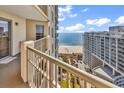 Stunning ocean view from a condo balcony, featuring a table and chairs at 9994 Beach Club Dr. # 1606, Myrtle Beach, SC 29572