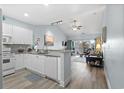 Open kitchen with white cabinets, granite counters, and stainless steel appliances at 1009 World Tour Blvd. # 304, Myrtle Beach, SC 29579