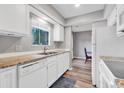 Kitchen boasts granite countertops, white cabinets, and modern appliances at 102 Berry Tree Ln., Conway, SC 29526