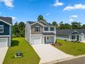 Two-story house with gray siding, a gray roof, and a two-car garage at 1041 Kinness Dr., Conway, SC 29527