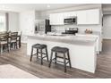 Open concept kitchen with island, stainless steel appliances, and hardwood floors at 1075 Oak Meadow Dr., Conway, SC 29526