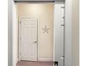Neutral hallway showcasing a starfish wall hanging, and a doorway to another room at 1109 Peace Pipe Ln. # 201, Myrtle Beach, SC 29579