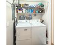Efficient laundry area with appliances, storage shelves, and compact design at 1109 Peace Pipe Ln. # 201, Myrtle Beach, SC 29579