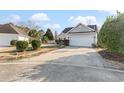 Exterior view of the home featuring a two-car garage and well-maintained driveway at 1209 Peyton Ct., Myrtle Beach, SC 29588