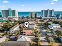 Aerial view of a multi-story beach home situated near the ocean and hotels at 124 Rainbow Dr., Murrells Inlet, SC 29576