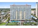 High-rise building with pool and surrounding landscape at 2000 N Ocean Blvd. # 301, Myrtle Beach, SC 29577