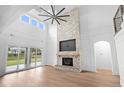 Two-story living room with hardwood floors, fireplace, and access to backyard at 215 82Nd Ave. N, Myrtle Beach, SC 29572