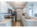 Cozy kitchen with stainless steel appliances, white cabinets, and a stylish backsplash, perfect for cooking at 2268 Essex Dr. # L, Surfside Beach, SC 29575