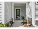 Covered front porch with decorative plants and tasteful accents provides a welcoming entrance at 2450 Craven Dr., Myrtle Beach, SC 29579