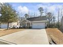 Inviting single-story home boasting a well-manicured front yard, two-car garage, and a welcoming covered porch at 261 Sea Turtle Dr., Myrtle Beach, SC 29579