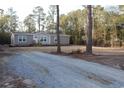 Tan mobile home with wood deck and landscaping at 2901 N Nichols Hwy., Nichols, SC 29581