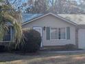 House exterior view with green roof and landscaping at 334 Lincolnshire Dr., Georgetown, SC 29440
