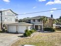 Two-story home with attached two-car garage and landscaped yard at 3545 Marion Ln., Murrells Inlet, SC 29576