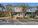 Two-story townhouse with balcony, palm trees, and parking at 3866 Highway 17 Business South # C-10, Murrells Inlet, SC 29576