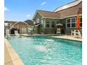 Relaxing pool with water features, lounge chairs, and a manicured backyard, perfect for outdoor enjoyment at 400 Dog Pen Ct., Myrtle Beach, SC 29579