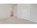 Spacious bedroom with neutral walls, carpet flooring, and a door to a hallway at 4131 Robin Song Way, Loris, SC 29569