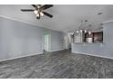 Open living area with wood-look tile floors and kitchen views at 4200 Coquina Harbour Dr. # H3, Little River, SC 29566
