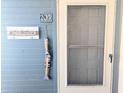 Beach house entrance featuring coastal decor, including fish and beach themed ornaments and unit number, offering curb appeal at 4305 N Ocean Blvd. # 205, North Myrtle Beach, SC 29582