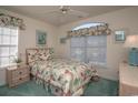 Charming bedroom with floral bedding and window seat at 4625 Lightkeepers Way # L, Little River, SC 29566
